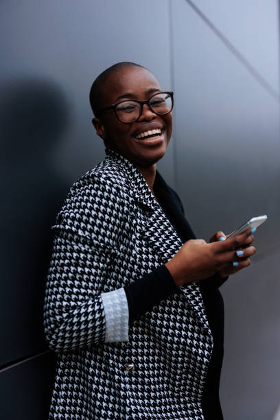 istock Trendy businesswoman using cellphone. 1443642709