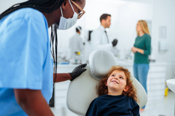 istock Cheerful child with assistant at dentist. 1443642917