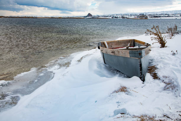 istock Fishing boat at snow covered beach 1443643548