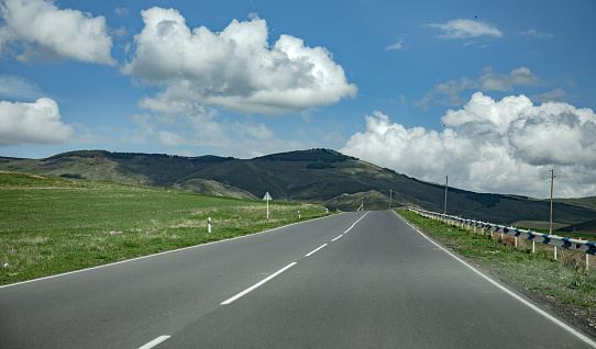 Asphalt road going through the hills