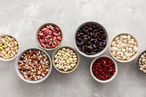 Different types of beans in bowls, economically important legume, top view, copy space