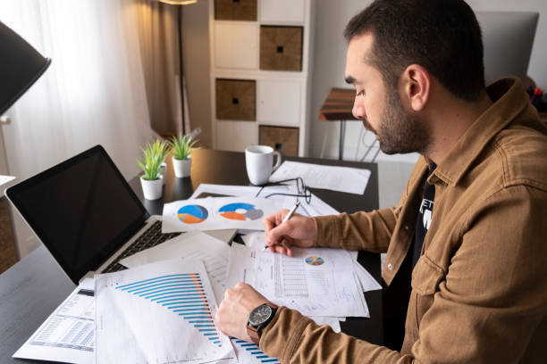 istock Focused businessman sit at workplace desk working on laptop 1443646668