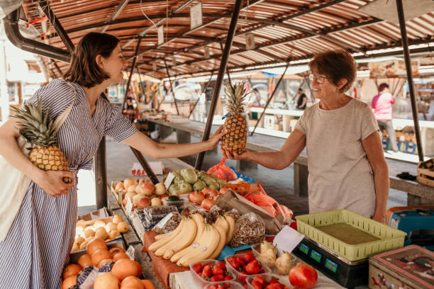 istock Market vendor selling fruits 1443646867