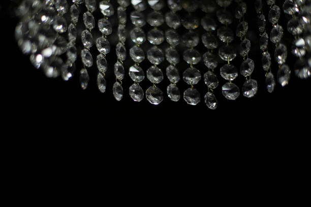 istock Crystal chandelier on black background. Interior details. Light in room. Light source. Glass sticks. 1443646895