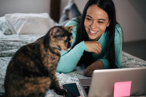 istock Woman is laying in bed with her cat. 1443650732