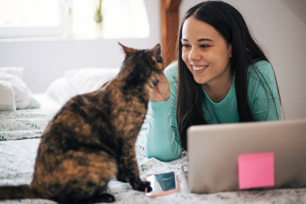 istock Woman is laying in bed with her cat. 1443650777