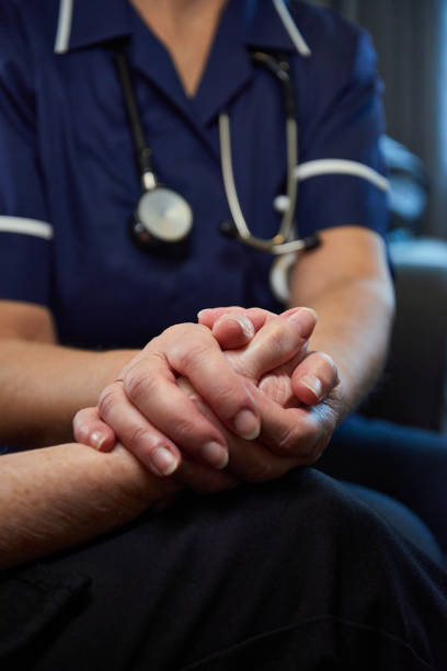 istock Nurse comforting senior patient 1443653964