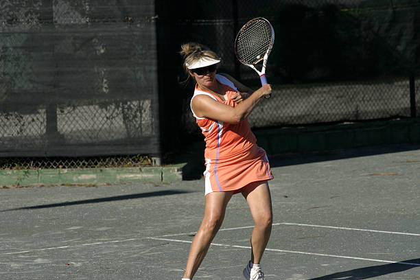 istock blonde tennis player in action 144365472