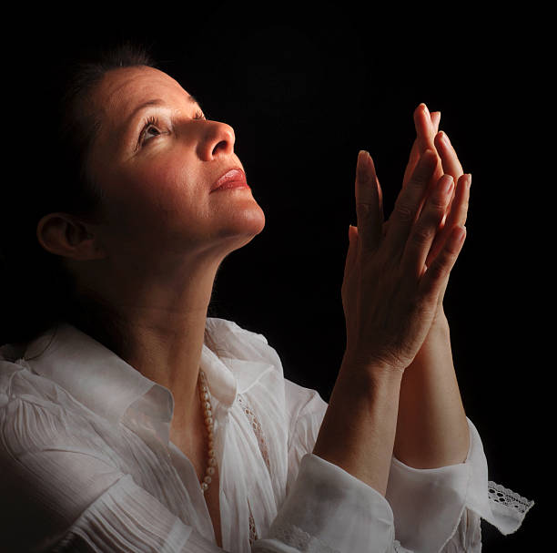 istock Woman in prayer 144365524