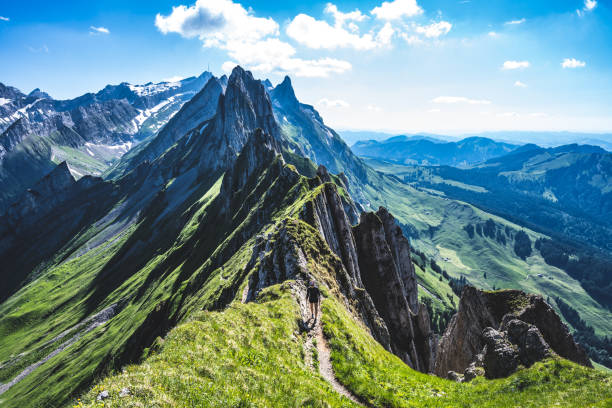 Hiker is walking along the a beautiful altitude path