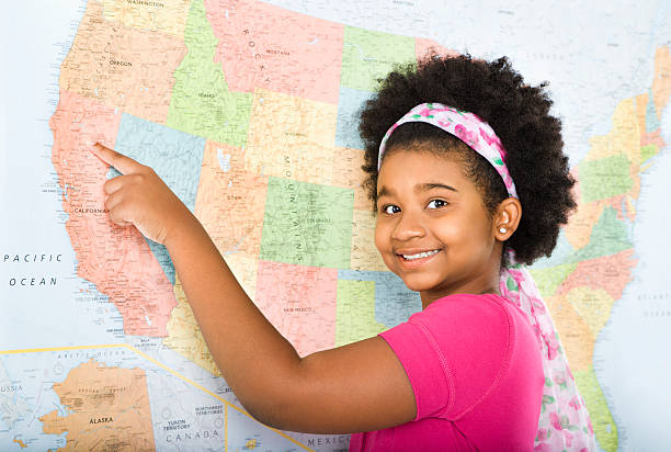 Girl pointing to map. stock photo