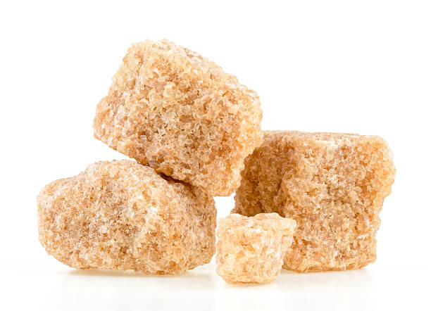istock Brown cane sugar cubes isolated on a white background. Unrefined demerara sugar pieces. 1443658756