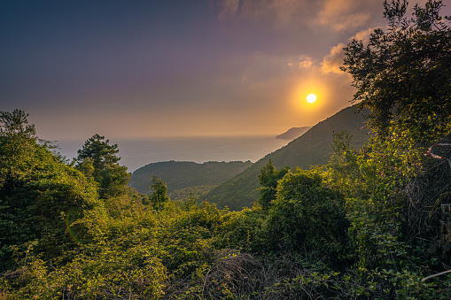 Sunset over of Cinque Terre on a hiking trail between the towns of Manarola and Corniglia, Italy