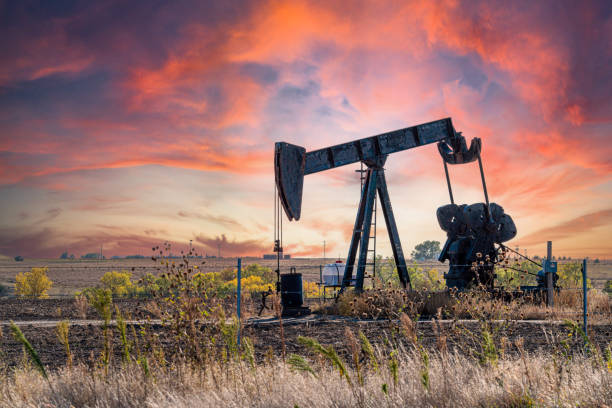 Oil Pump Jack in the Middle of Kansas with a Beautiful Sunset Background with Copy Space American Oil Pump Jack Producing Oil from The Ground in Kansas at Sunset or Sunrise. Image Taken Near the Town of Hays, Kansas, USA
Use of Crude Oil Is a Controversial Topic in The American Election Cycle and Among Financial Circles. oil wellhead stock pictures, royalty-free photos & images