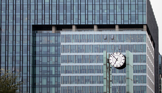 Clock in the Business Center. Clock in Front of an Office Building.