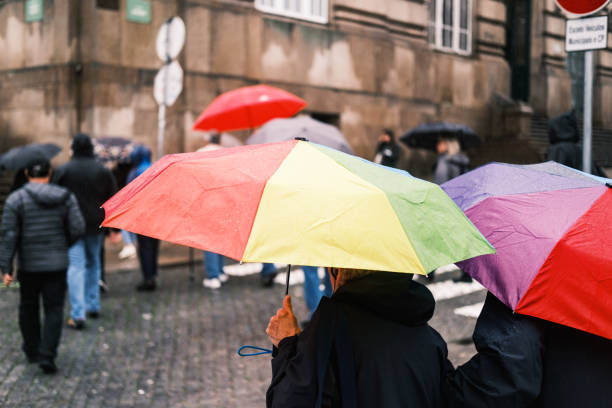 Porto, Portugal; November 20, 2022: Several people walking around the port while it was raining had to open their umbrellas