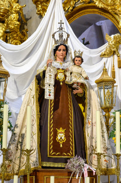 Alicante, Spain - November 10, 2022: Medieval statue of the Virgin Mary on the altar of the Basilica of Santa Maria Church. The medieval Catholic church is a significant tourist attraction in the Spanish city.