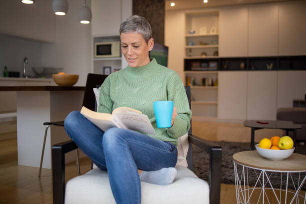 istock Woman relaxing and reading a book 1443666353