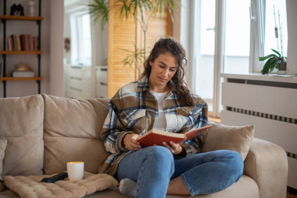 istock Woman relaxing and reading a book 1443667147