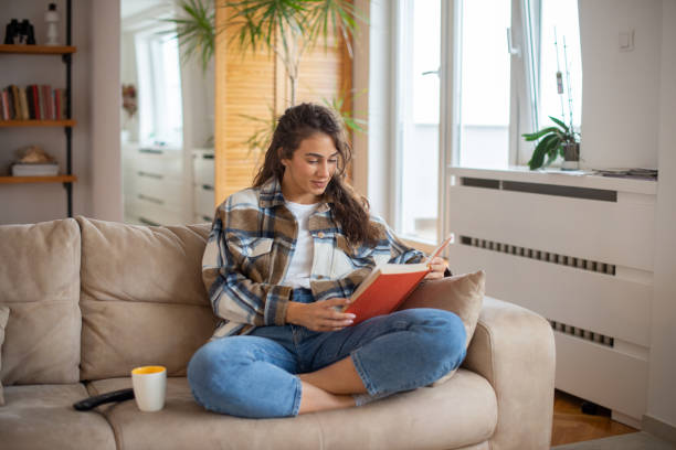 istock Woman relaxing and reading a book 1443667160