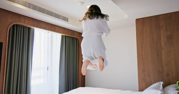 istock woman jump on bed 1443668000
