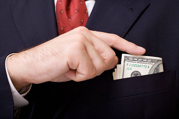 Boutonniere with money Putting money in boutonniere close up. Business concept. greedy corporation stock pictures, royalty-free photos & images