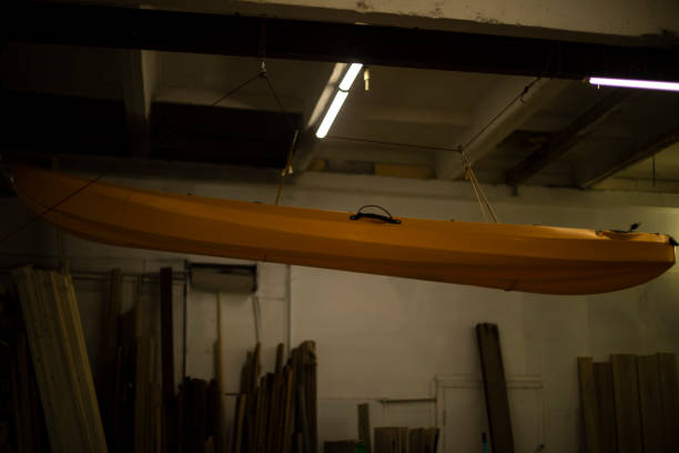 istock Boat hangs from ceiling. Boat in garage. Yellow water transport. 1443669944