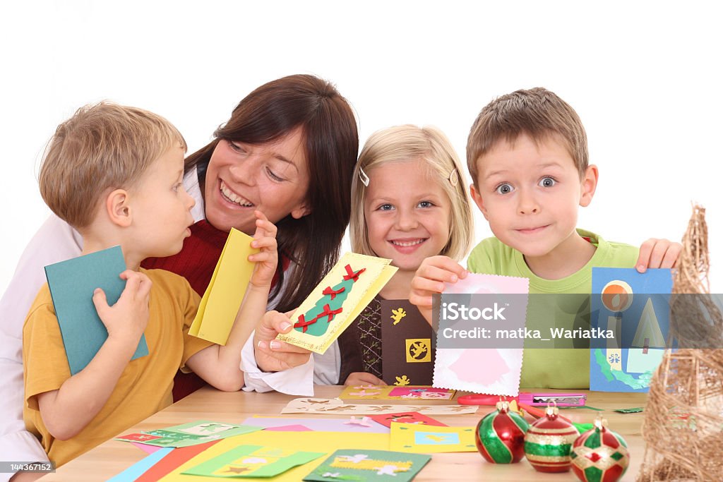 Mother and children making Christmas cards mother and children making Christmas cards /all cards are made by mother and children/ 2-3 Years Stock Photo