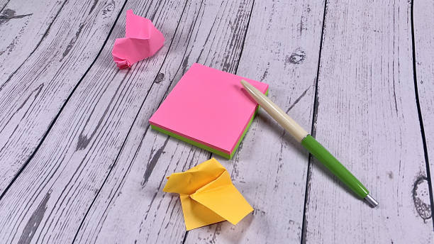 istock Post it mockup papers on the white wooden background. Colorful note paper mockups. 1443675021