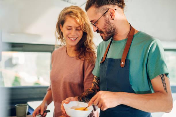 istock Young couple making breakfast together in the kitchen at home 1443675433
