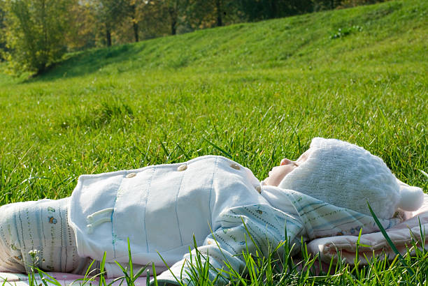 Baby sleeping outdoors stock photo