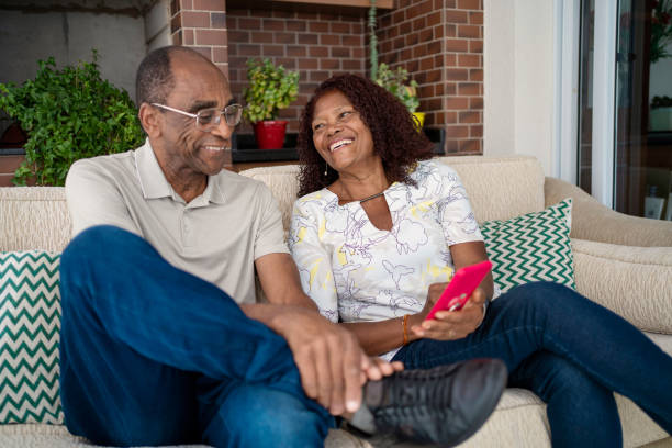 istock African American senior couple using smart phone in the sofa 1443682890