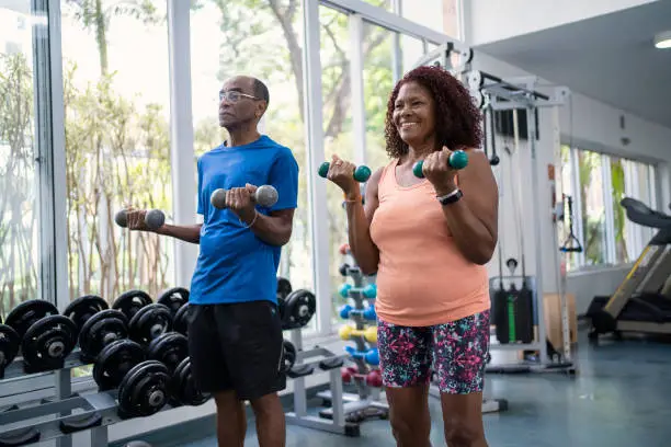 Photo of African American senior couple working out together