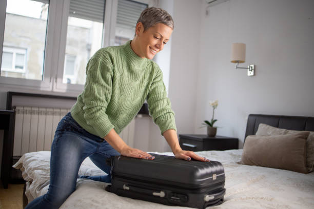 istock Woman organizing her luggage 1443683687