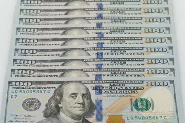 istock One hundred dollar bills lays on each other. 1443686609