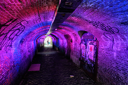 Utrecht, Netherlands - May 25, 2018: Illuminated Ganzemarkt tunnel to Oudegracht in the old city centre of Utrecht, Netherlands