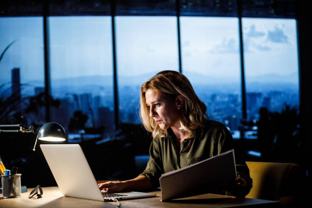 istock Businesswoman comparing data on laptop and paperwork when working on a project 1443687064