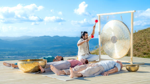 istock People group at music therapy session, man playing gong, wide shot 1443687146