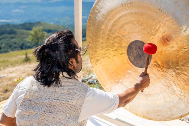 istock Man playing bronze gong with drumsticks, alternative medicine 1443687187