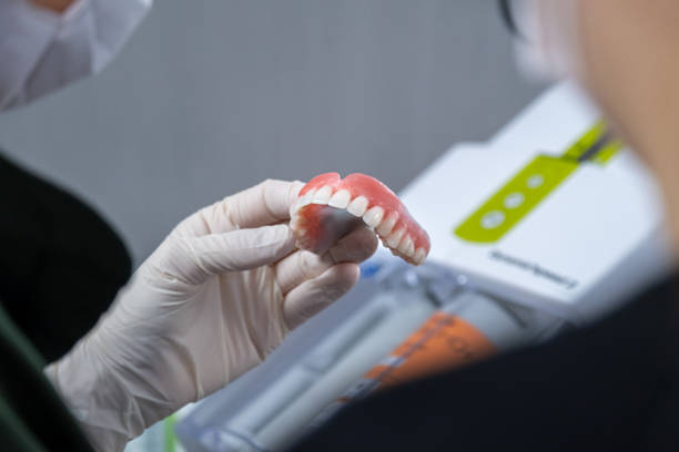 istock Dentist fine-tunes prosthetic upper tooth 1443690469