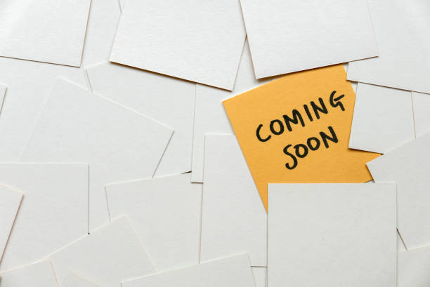 istock A yellow card among an empty white card written with coming soon. 1443700683