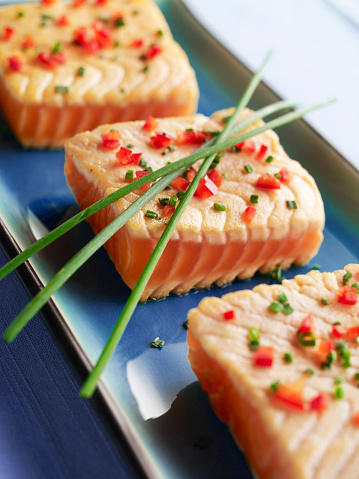 Broiled salmon dish with fresh VEGETABLE GARNISH