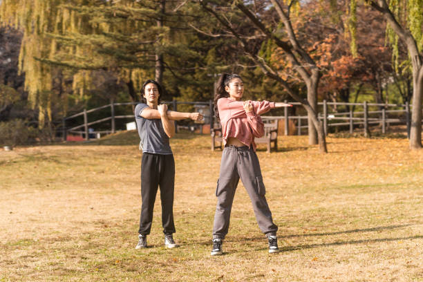 Asian Man and Woman Exercising