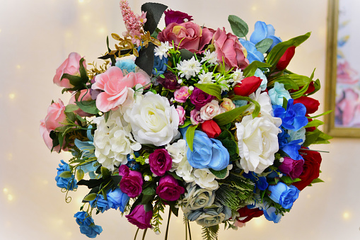 Vase with colorful artificial flowers decorating the birthday party table