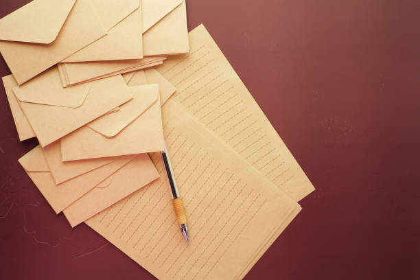 envelope , empty paper and fountain pen on table .