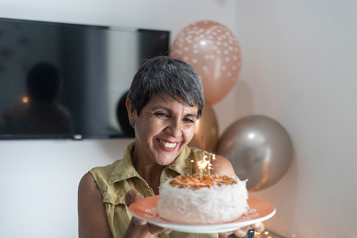 Latin woman portrait with birthday cake