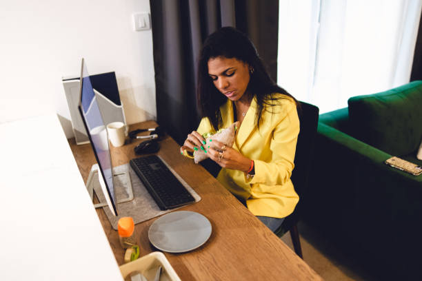 istock Latina female adult working from home using a desktop PC 1443720685