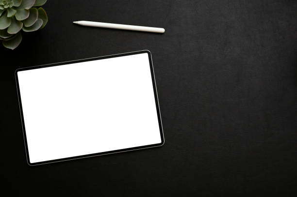 istock Modern black workspace with tablet mockup, pen and decor plant on black background. top view 1443721399
