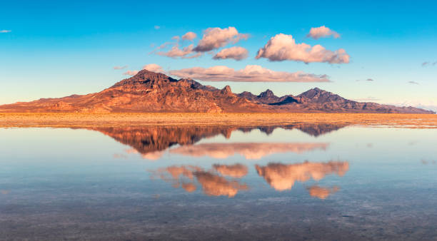 After an overnight snowstorm, the snow melted and covered the area with water.  The water provided an excellent reflection of the nearby mountains, sky and clouds.