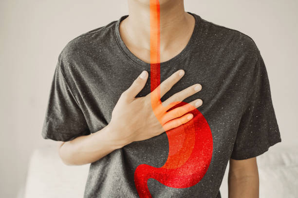 Young man having  heartburn, Gastroesophageal reflux disease (GERD) or acid reflux symptom, health care concept stock photo